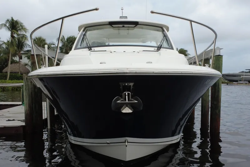  Yacht Photos Pics 2022 Pursuit OS 355 Offshore boat docked, front view with palm trees in background.
