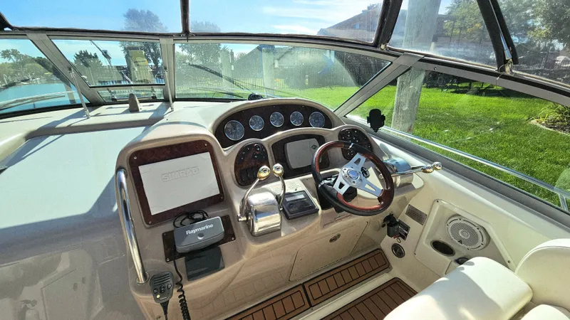  Yacht Photos Pics 2003 Sea Ray 340 Sundancer helm with steering wheel, gauges, and navigation equipment.