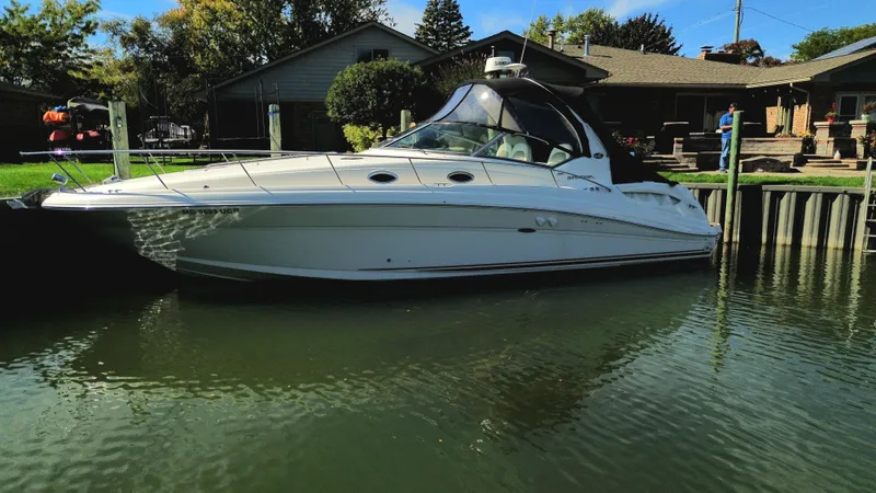  Yacht Photos Pics 2003 Sea Ray 340 Sundancer yacht docked by a waterfront home.