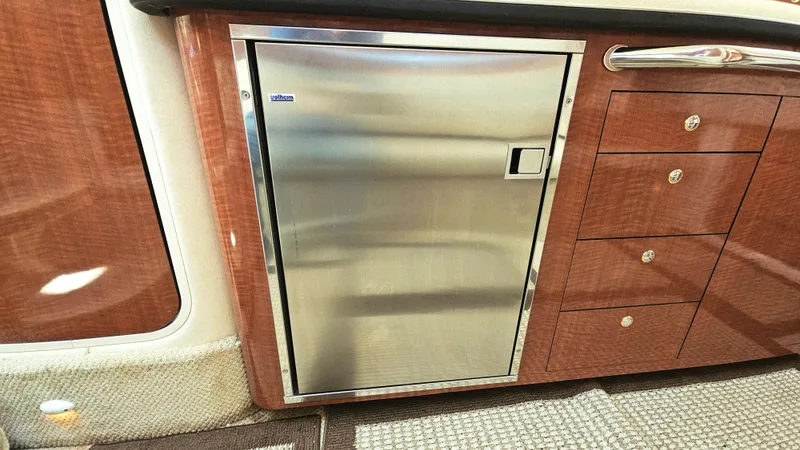  Yacht Photos Pics Stainless steel fridge and wooden cabinetry in 2003 Sea Ray 340 Sundancer yacht interior.