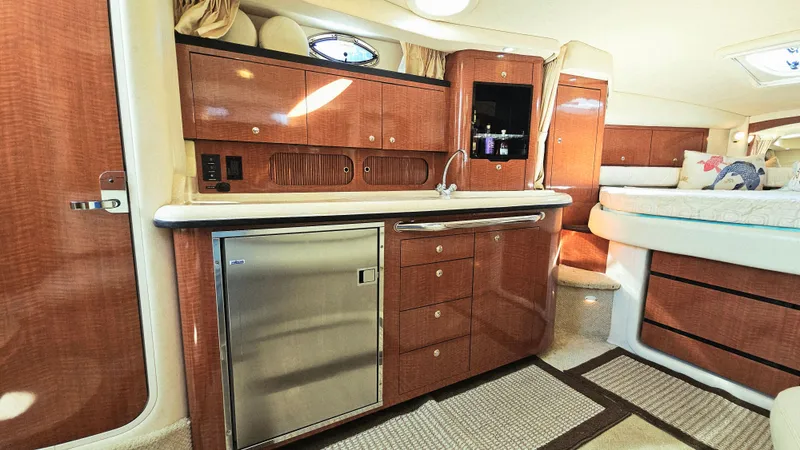  Yacht Photos Pics Interior of 2003 Sea Ray 340 Sundancer yacht with kitchenette and cozy sleeping area.