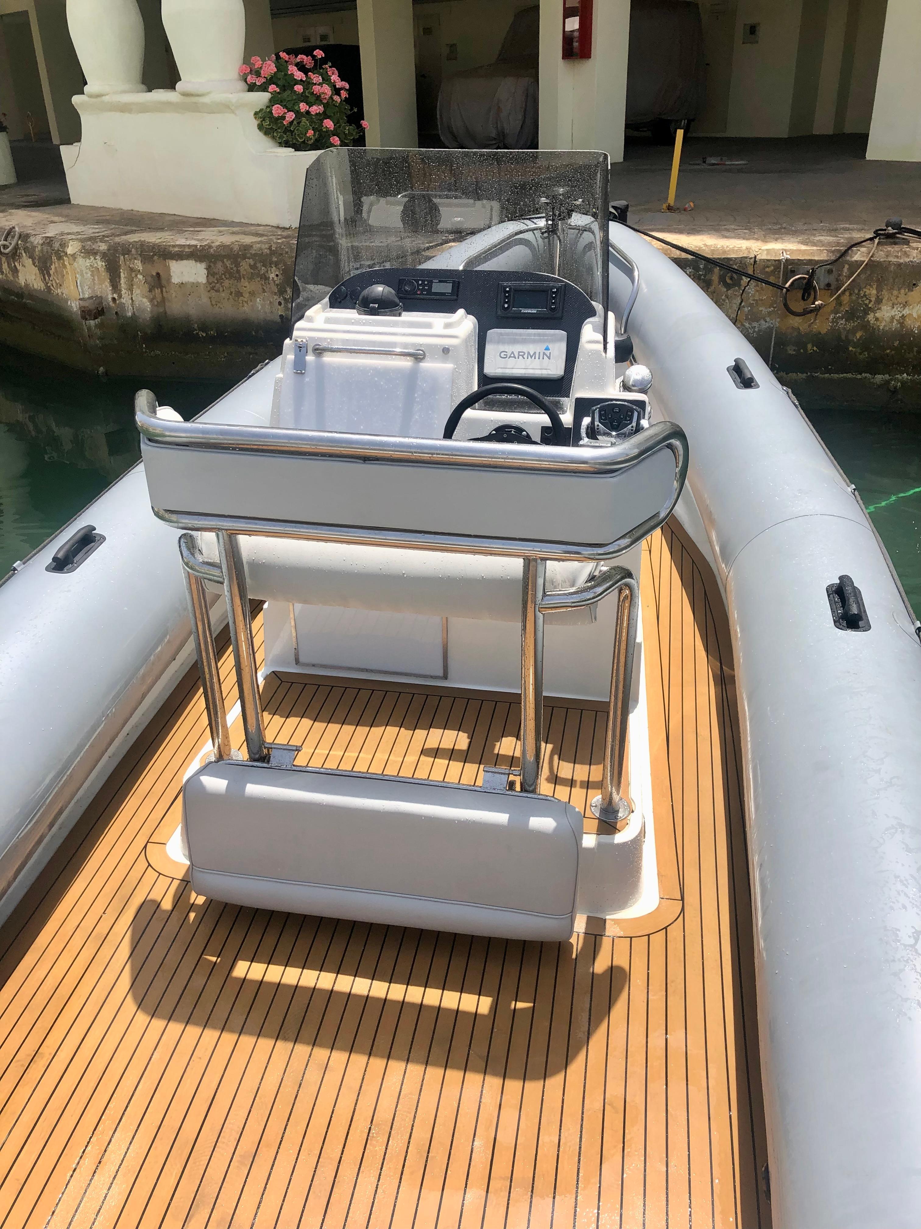 2005 Protector RIB 8.75m boat with wooden deck and modern console.
