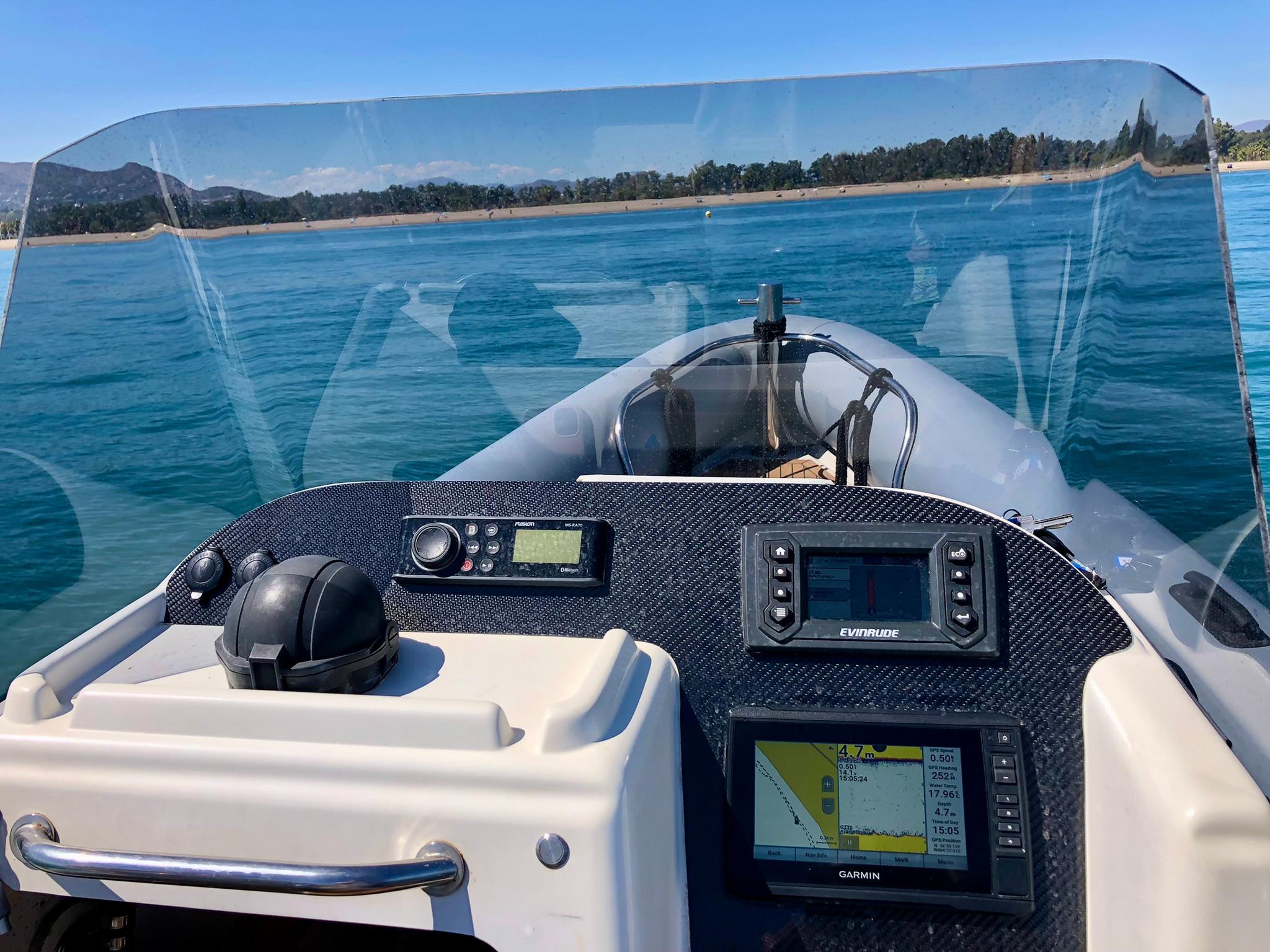 2005 Protector RIB 8.75m boat dashboard with navigation equipment on calm water.