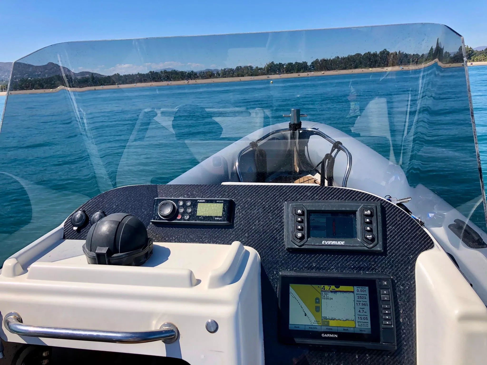 2005 Protector RIB 8.75m boat dashboard with navigation equipment on calm water.