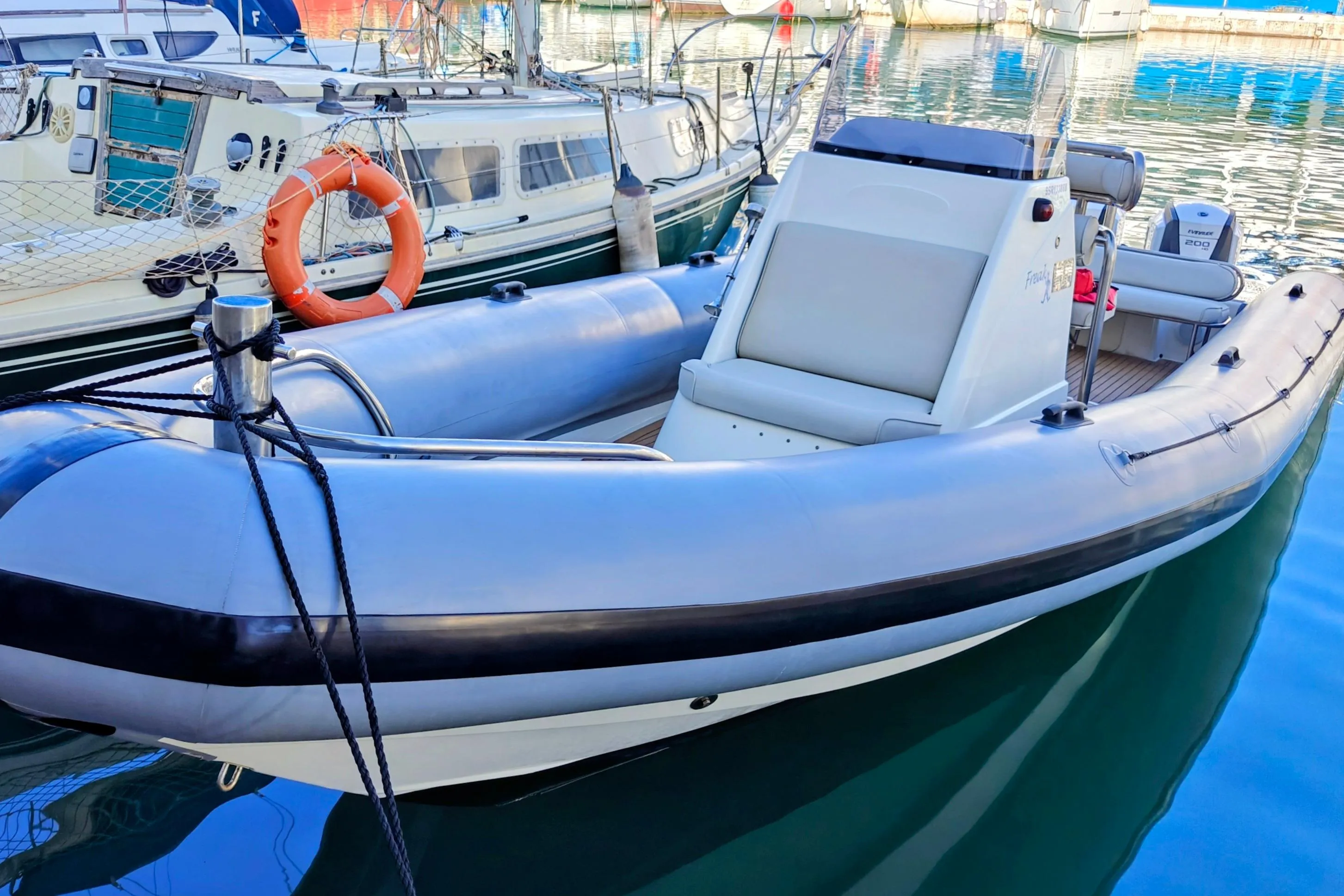 2005 Protector RIB 8.75m boat docked in a marina, featuring sleek design and modern equipment.