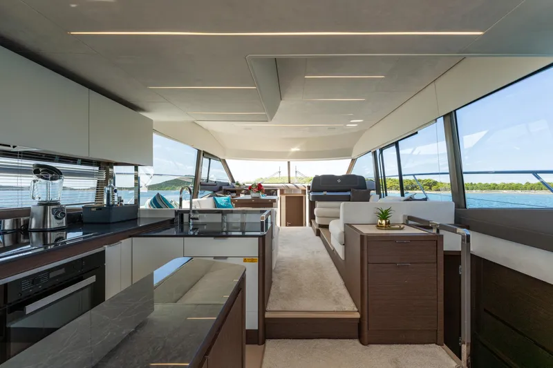 The Sun Yacht Photos Pics Luxurious interior of 2020 Prestige 590 yacht with modern kitchen and panoramic windows.