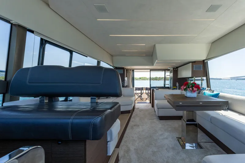 The Sun Yacht Photos Pics Luxurious interior of 2020 Prestige 590 yacht with elegant seating and ocean view.