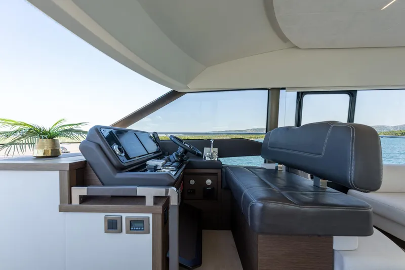 The Sun Yacht Photos Pics Luxurious interior of 2020 Prestige 590 yacht with modern helm and leather seating.