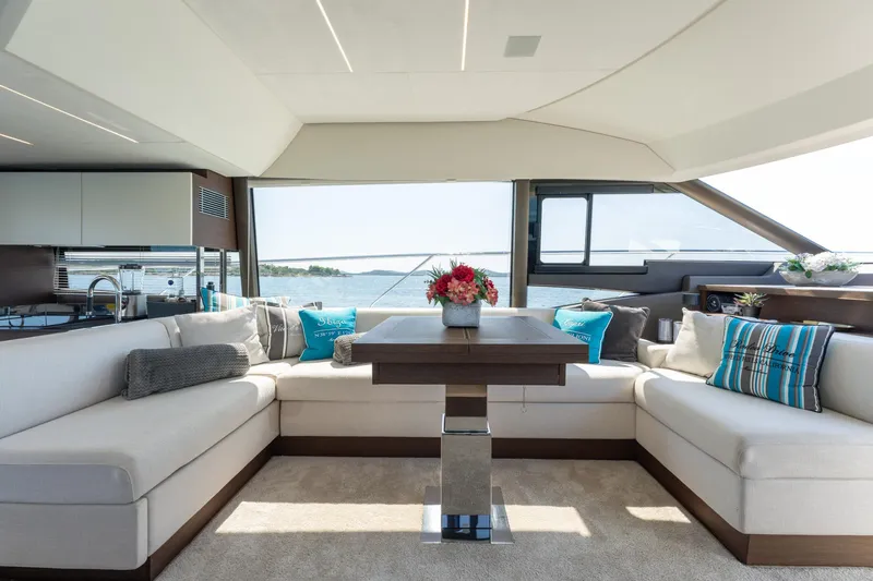 The Sun Yacht Photos Pics Luxurious interior of 2020 Prestige 590 yacht with elegant seating and scenic ocean view.