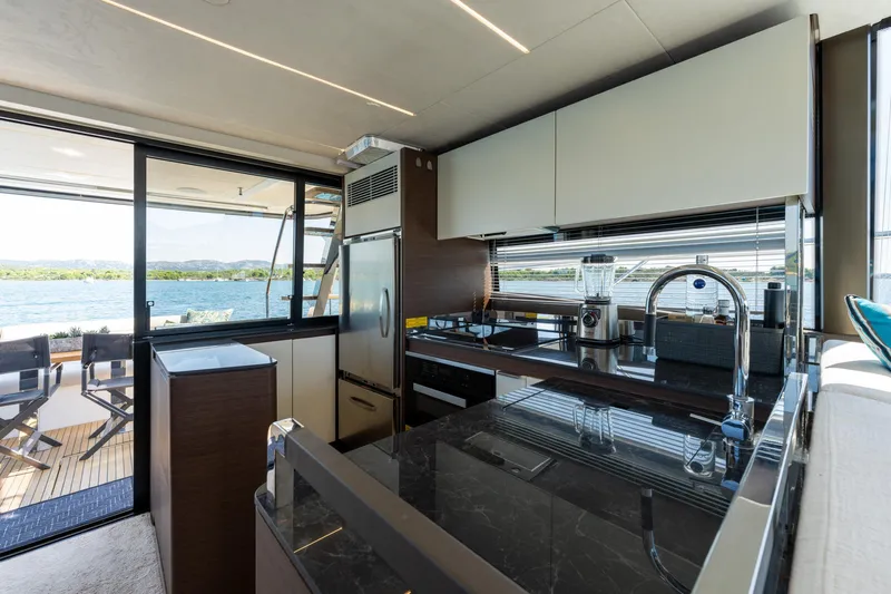 The Sun Yacht Photos Pics Luxurious kitchen interior of 2020 Prestige 590 yacht with scenic water view.