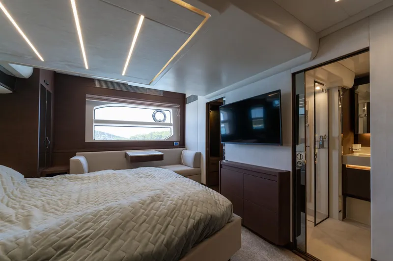 The Sun Yacht Photos Pics Luxurious interior of 2020 Prestige 590 yacht bedroom with modern design and amenities.