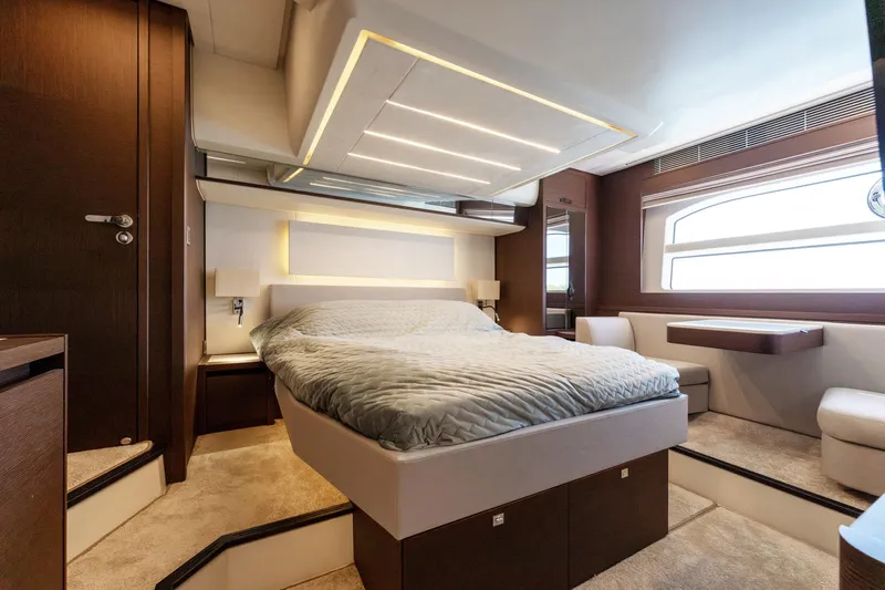 The Sun Yacht Photos Pics Luxurious bedroom interior of 2020 Prestige 590 yacht with modern design and elegant furnishings.
