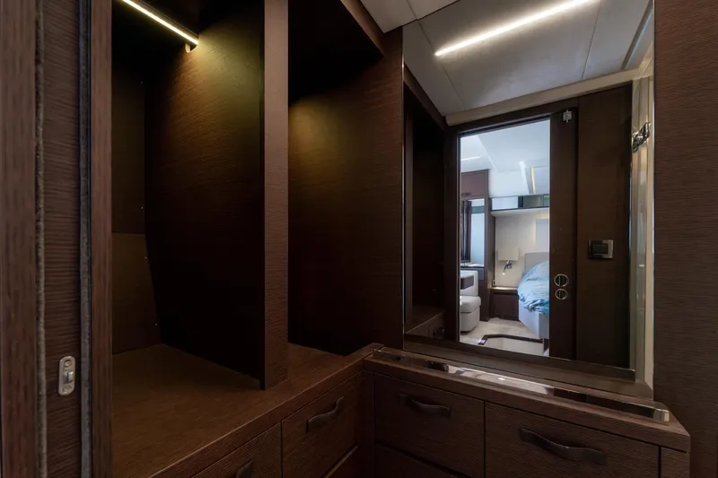 The Sun Yacht Photos Pics Luxurious interior of 2020 Prestige 590 yacht with dark wood cabinetry and modern design.