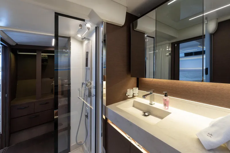 The Sun Yacht Photos Pics Luxurious bathroom interior of 2020 Prestige 590 yacht with modern fixtures and elegant design.