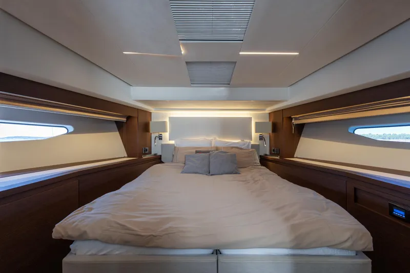 The Sun Yacht Photos Pics Luxurious bedroom interior of 2020 Prestige 590 yacht with modern design and ambient lighting.