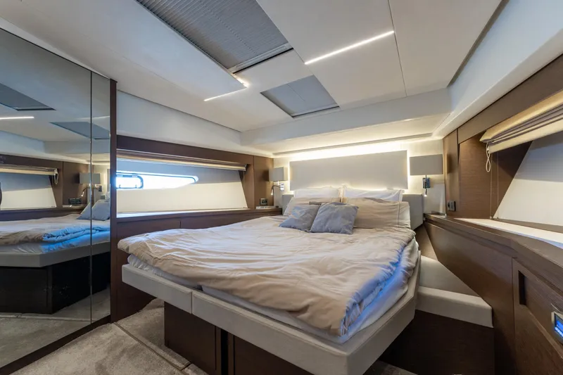 The Sun Yacht Photos Pics Luxurious bedroom interior of 2020 Prestige 590 yacht with modern design and ambient lighting.