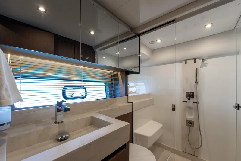 The Sun Yacht Photos Pics Luxurious bathroom interior of 2020 Prestige 590 yacht with modern fixtures and glass shower.