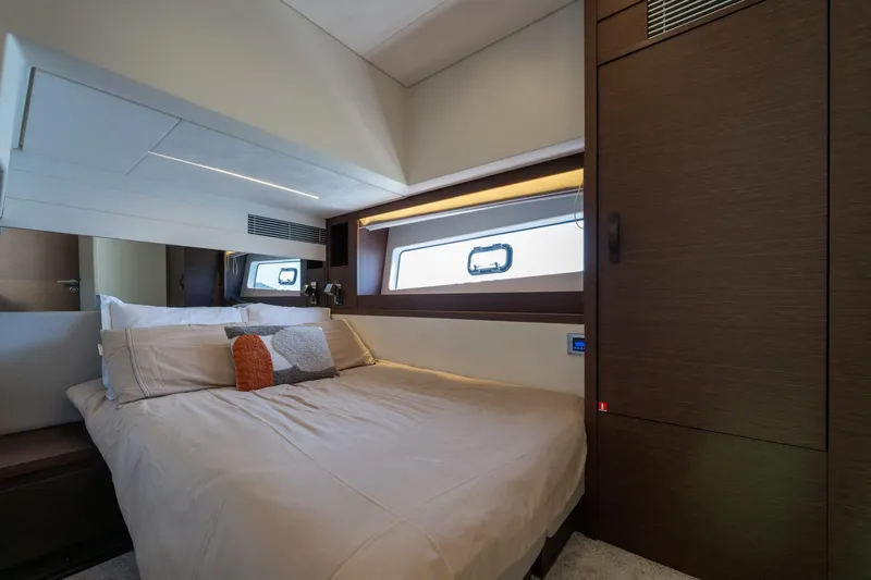 The Sun Yacht Photos Pics Luxurious cabin interior of 2020 Prestige 590 yacht with modern design and cozy bedding.