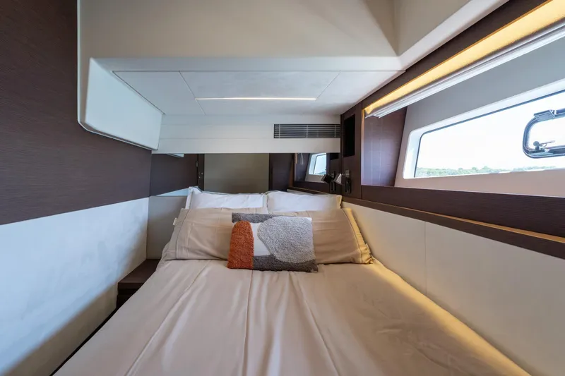 The Sun Yacht Photos Pics Luxurious cabin interior of 2020 Prestige 590 yacht with modern bedding and window view.