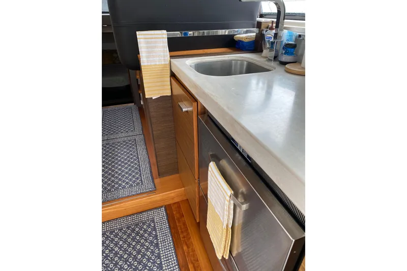 Rosalinda Yacht Photos Pics Modern kitchen interior of 2015 Tiara Yachts C44 Coupe with stainless steel appliances.