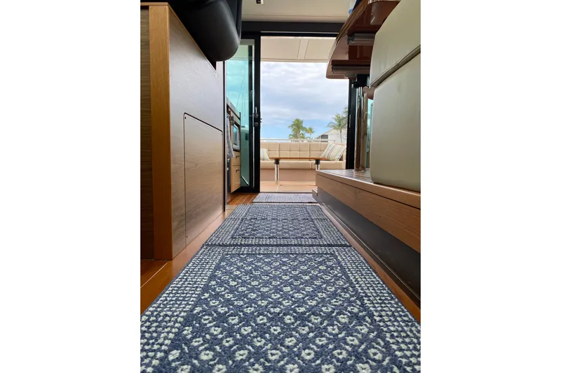 Rosalinda Yacht Photos Pics Interior view of 2015 Tiara Yachts C44 Coupe, featuring elegant wood finishes and patterned carpet.