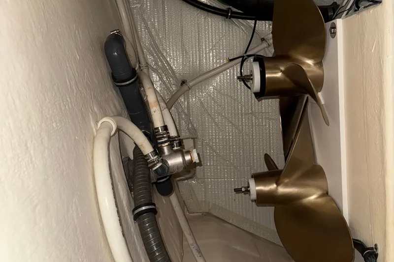 Rosalinda Yacht Photos Pics Engine room of 2015 Tiara Yachts C44 Coupe with propeller and plumbing components.