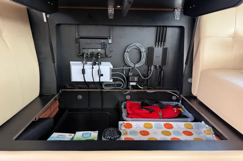 Rosalinda Yacht Photos Pics 2015 Tiara Yachts C44 Coupe interior storage with Garmin electronics and organized compartments.