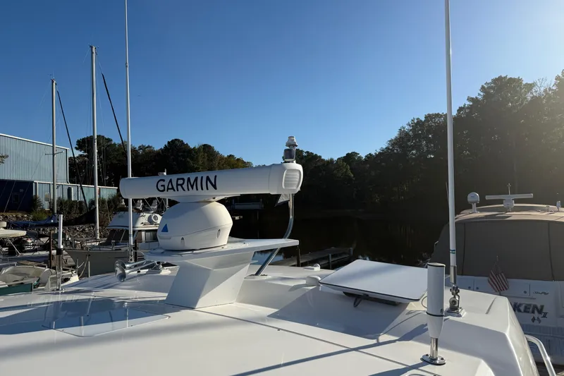 Rosalinda Yacht Photos Pics 2015 Tiara Yachts C44 Coupe with Garmin radar at marina, clear sky background.