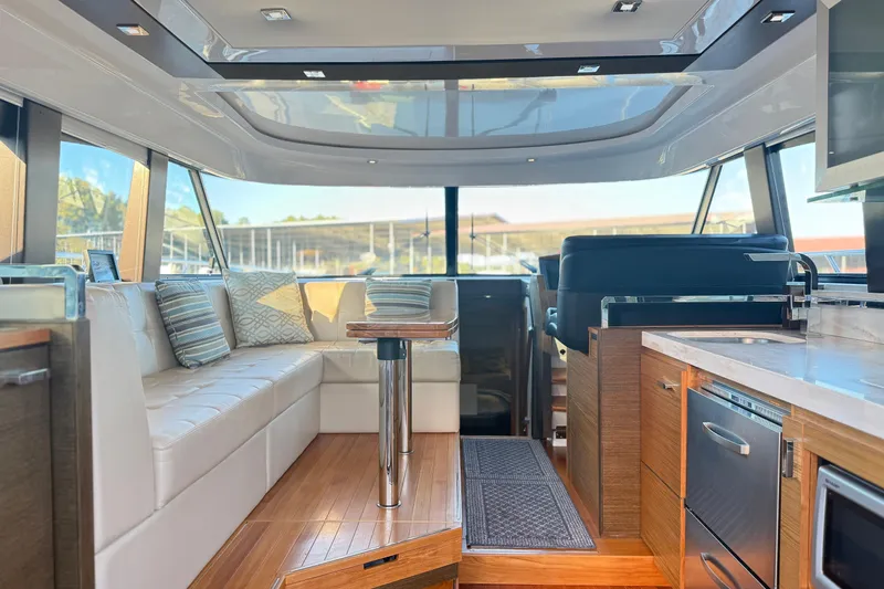 Rosalinda Yacht Photos Pics Luxurious interior of 2015 Tiara Yachts C44 Coupe with modern seating and kitchen amenities.