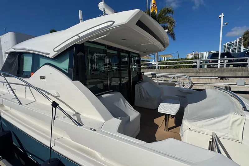Rosalinda Yacht Photos Pics 2015 Tiara Yachts C44 Coupe docked, showcasing sleek design and spacious deck area.