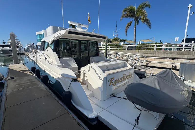 Rosalinda Yacht Photos Pics 2015 Tiara Yachts C44 Coupe docked at marina under clear blue sky.