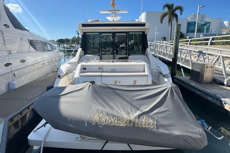 Rosalinda Yacht Photos Pics 2015 Tiara Yachts C44 Coupe docked at marina, covered equipment labeled "Rosalinda."