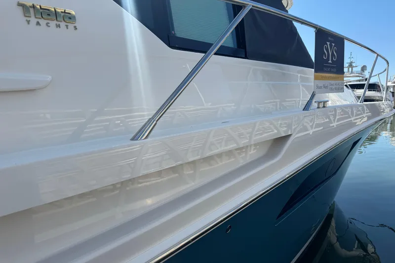 Rosalinda Yacht Photos Pics 2015 Tiara Yachts C44 Coupe side view with railing and logo.