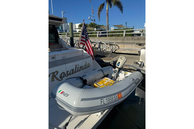 Rosalinda Yacht Photos Pics 2015 Tiara Yachts C44 Coupe with dinghy, docked under clear blue sky.