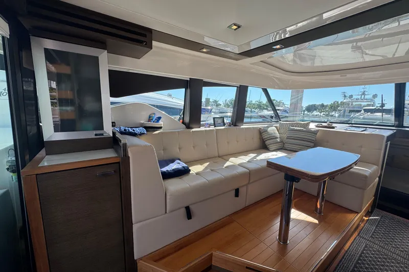 Rosalinda Yacht Photos Pics Luxurious interior of 2015 Tiara Yachts C44 Coupe with plush seating and elegant table.