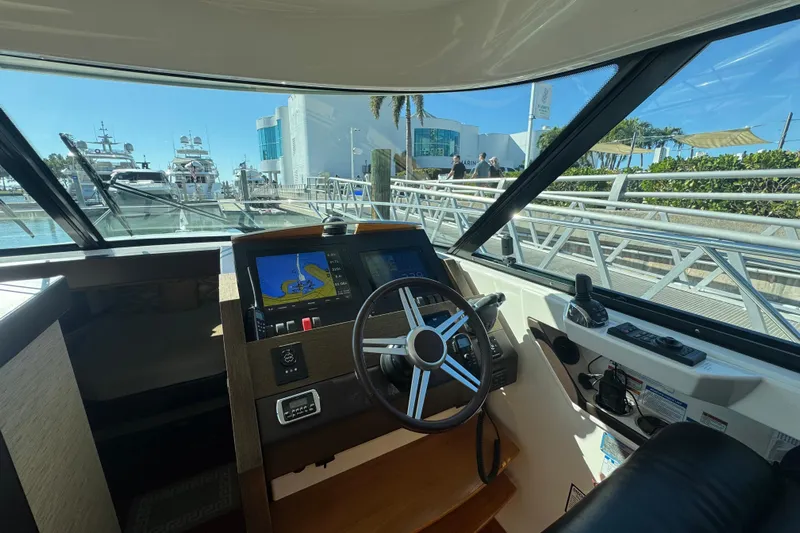 Rosalinda Yacht Photos Pics Interior view of 2015 Tiara Yachts C44 Coupe helm with navigation screens and steering wheel.