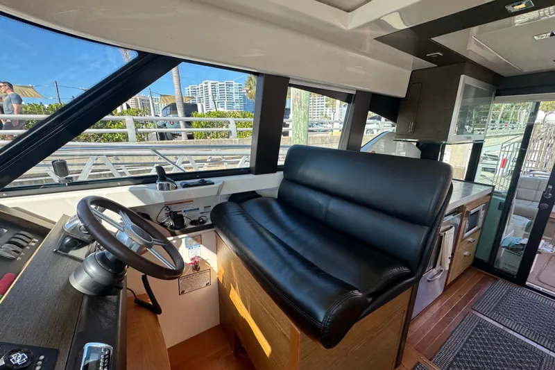 Rosalinda Yacht Photos Pics Interior view of 2015 Tiara Yachts C44 Coupe helm with leather seating and modern controls.