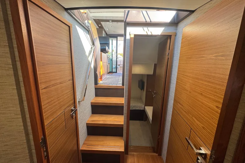 Rosalinda Yacht Photos Pics Interior of 2015 Tiara Yachts C44 Coupe, featuring wooden doors and stairs.