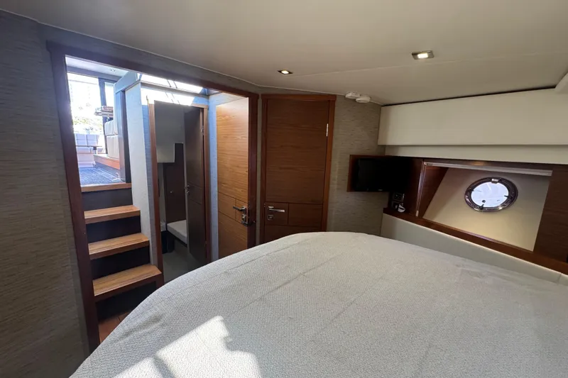 Rosalinda Yacht Photos Pics Interior cabin of 2015 Tiara Yachts C44 Coupe with stairs and porthole window.