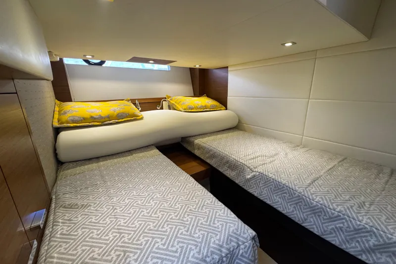 Rosalinda Yacht Photos Pics Interior cabin of 2015 Tiara Yachts C44 Coupe with twin beds and yellow pillows.
