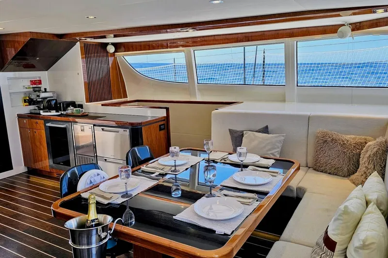  Yacht Photos Pics Luxurious interior of 2016 HH Catamarans HH66 with elegant dining area and modern kitchen.