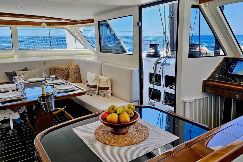  Yacht Photos Pics Luxurious interior of 2016 HH Catamarans HH66 with elegant dining area and ocean view.
