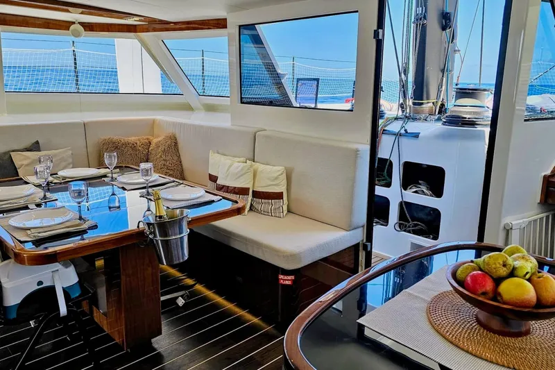  Yacht Photos Pics Luxurious interior of 2016 HH Catamarans HH66 with elegant dining area and ocean view.