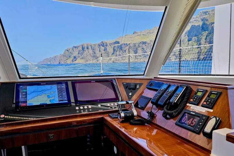  Yacht Photos Pics Cockpit view of 2016 HH Catamarans HH66, featuring navigation equipment and scenic ocean backdrop.