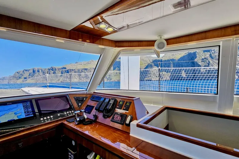  Yacht Photos Pics Interior view of 2016 HH Catamarans HH66 cockpit with navigation equipment and scenic ocean backdrop.