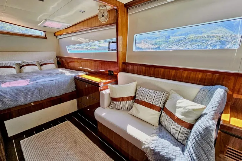  Yacht Photos Pics Luxurious 2016 HH Catamarans HH66 cabin interior with bed, sofa, and scenic window view.
