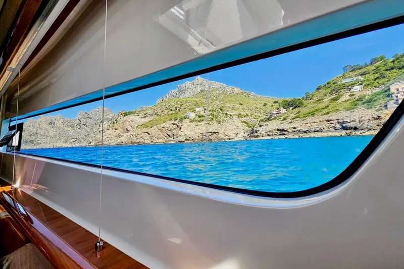  Yacht Photos Pics View from HH Catamarans HH66 (2016) window, showcasing stunning coastal landscape and blue waters.