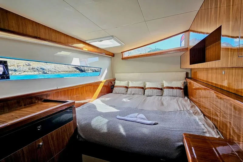  Yacht Photos Pics Luxurious cabin interior of 2016 HH Catamarans HH66 with elegant wood finish and scenic window view.
