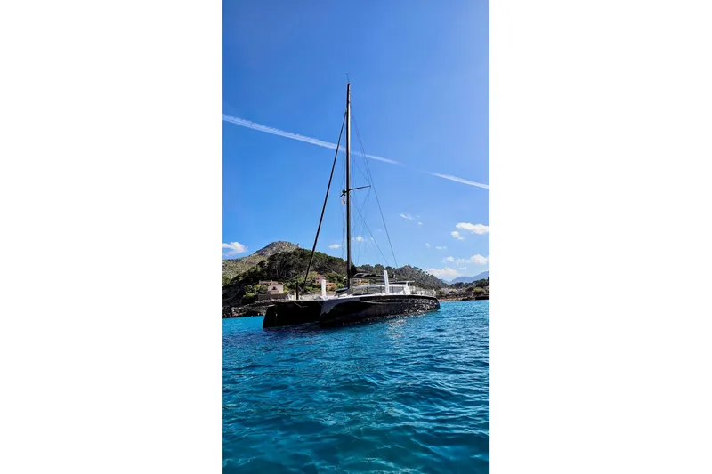  Yacht Photos Pics 2016 HH Catamarans HH66 sailing in clear blue waters with scenic mountain backdrop.