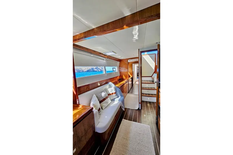  Yacht Photos Pics Luxurious interior of 2016 HH Catamarans HH66, featuring elegant wood finishes and comfortable seating.